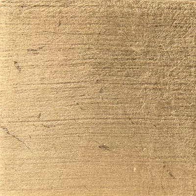 Close-up Gold Leaf: golden metallic surface with fine irregular brushing lines, featuring a soft sheen.