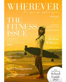 Wherever magazine cover: A young woman in sunglasses and a cap holds a skateboard against a sunset background.