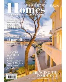 Press clipping of Perfect Homes magazine cover featuring a luxurious villa overlooking the sea.