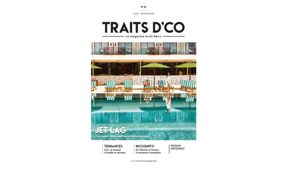 Press clipping of the Traits D'eco Magazine cover featuring a hotel pool area with lounges and umbrellas.