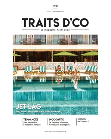 Press clipping of the Traits D'eco Magazine cover featuring a hotel pool area with lounges and umbrellas.