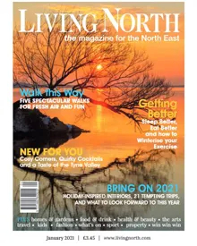 Living North magazine cover featuring a sunset over water with bare trees, January 2021 issue.