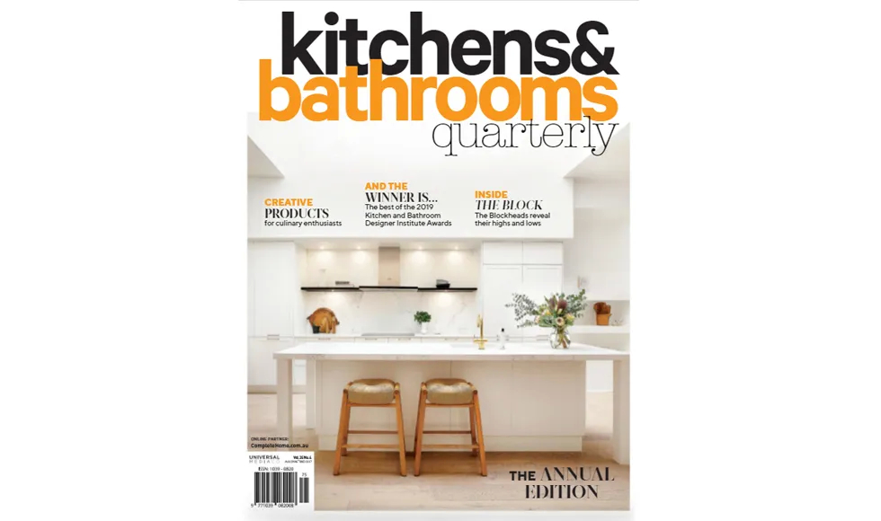 Kitchens & Bathrooms Quarterly cover with a modern white kitchen featuring a large island and bar stools.