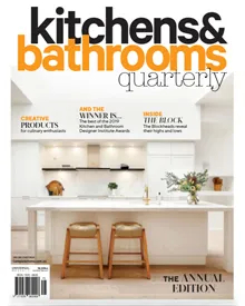 Kitchens & Bathrooms Quarterly cover with a modern white kitchen featuring a large island and bar stools.