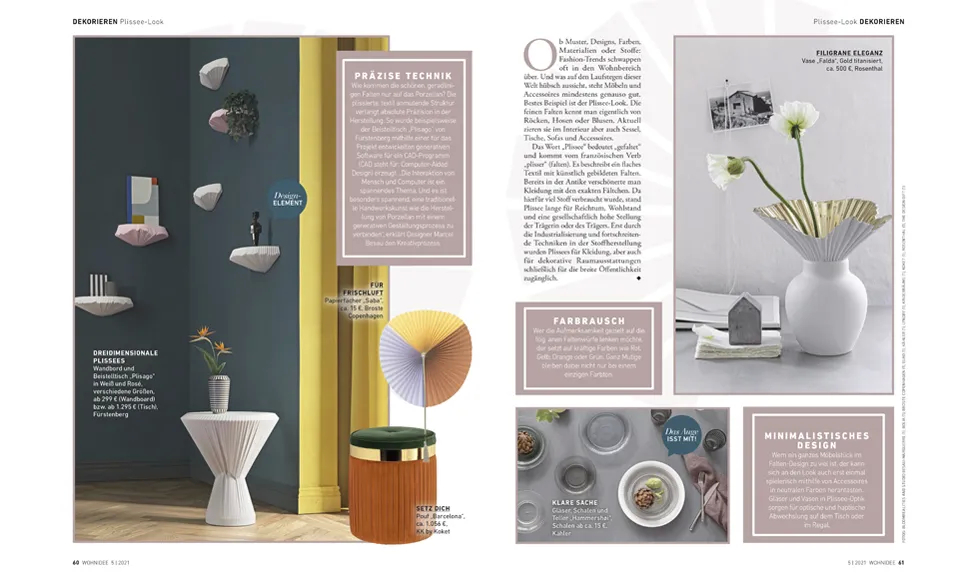 Wohnidee spread: modern decor with floating shelves, a green stool, and a gold-orange pleated Koket Barcelona stool.