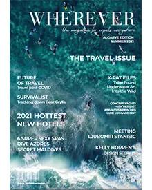 Wherever press clipping, the cover, featuring an aerial view of people surfing in blue ocean water.