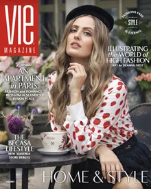 Vie Magazine cover featuring a woman in a strawberry-print shirt and beret, sitting at an outdoor table.