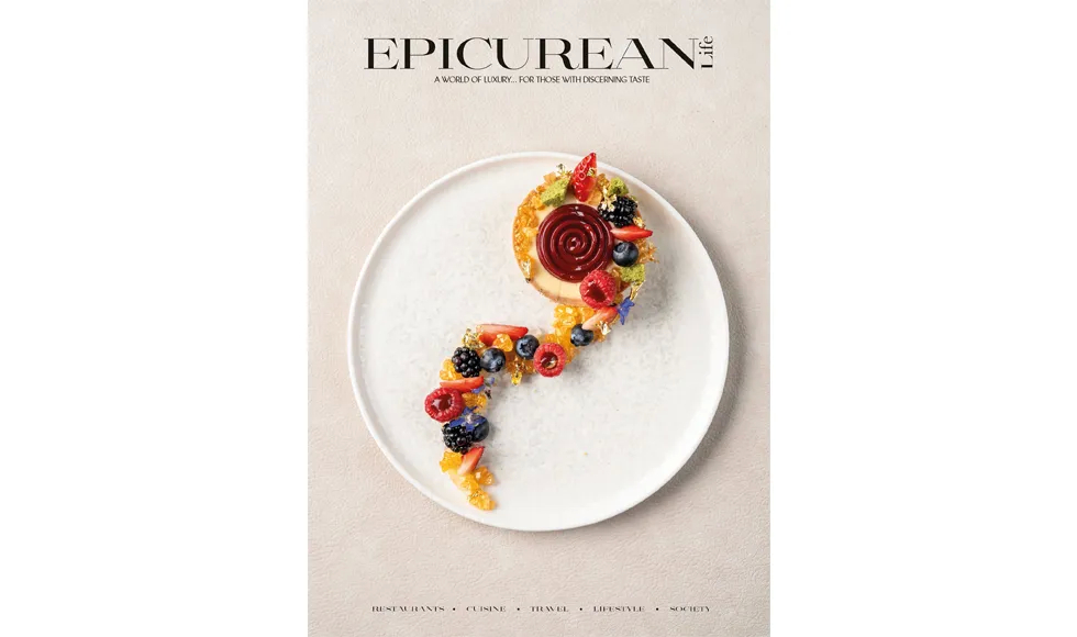 Cover of Epicurean Life, April 2024, featuring a smiling man and a beautifully plated dessert on a white dish.