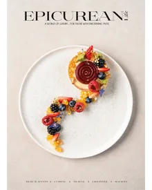 Cover of Epicurean Life, April 2024, featuring a smiling man and a beautifully plated dessert on a white dish.