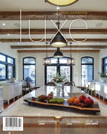 Cover of LUXE Magazine Ottawa, April 2024, showcasing a luxurious kitchen with exposed wooden beams and stylish lighting.