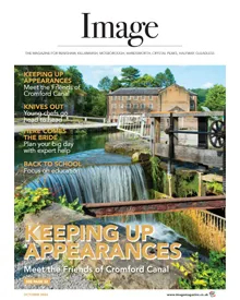 Press clipping of Image Magazine cover, October 2024, featuring a picturesque canal with a waterfall and historic building.