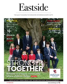 Press clipping of Eastside Magazine cover, October 2024, featuring a group of students and adults outdoors.