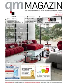 The QM Magazin cover features a modern living room with red sofas, showcasing real estate and living trends.