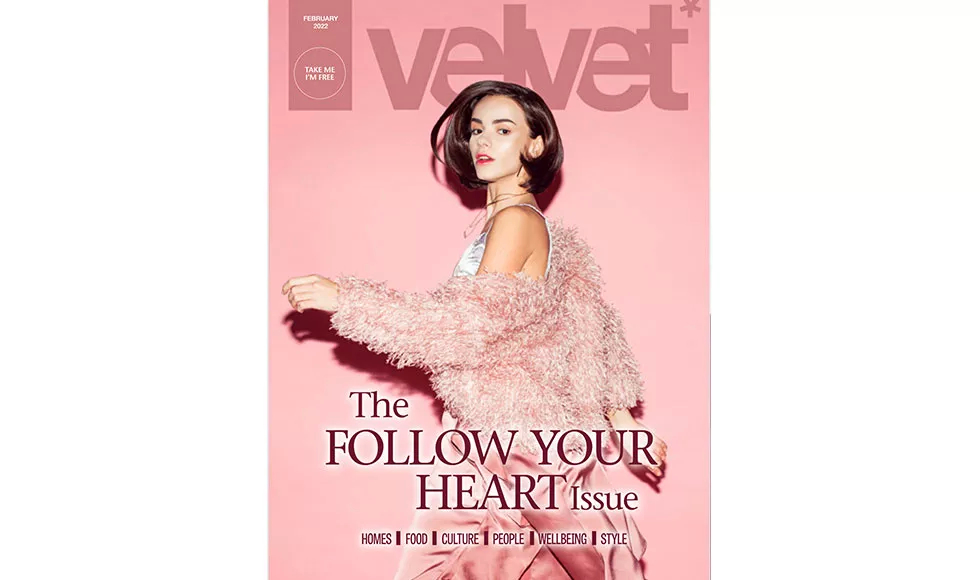 Press clipping of Velvet Magazine cover with a woman in a pink fluffy coat, "Follow Your Heart Issue".