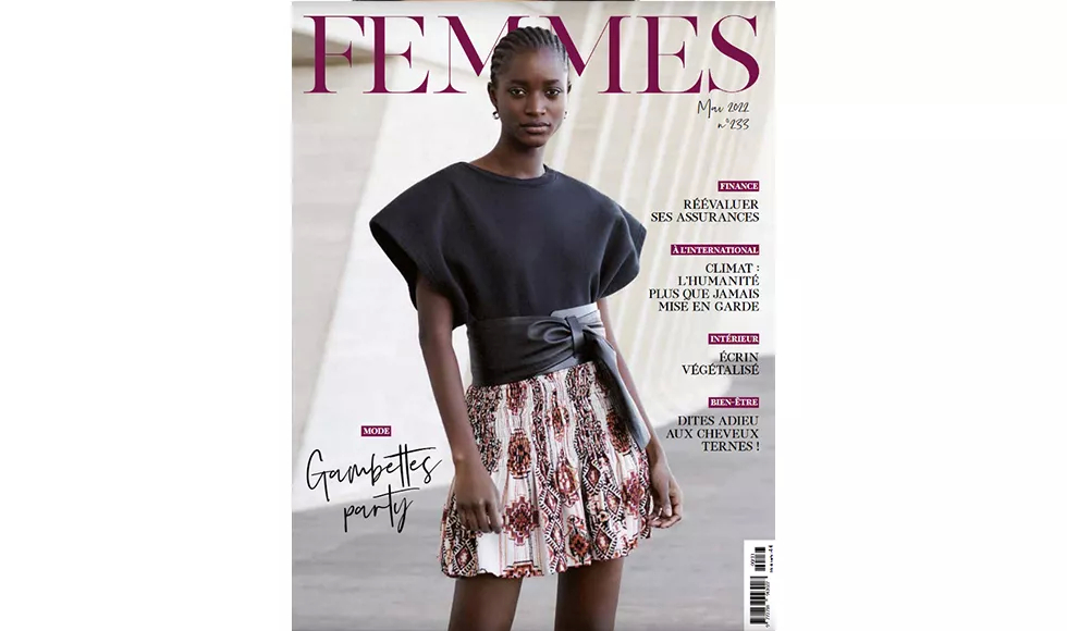 Magazine cover of Femmes featuring a dark-skinned woman in a black top and patterned skirt, with text in French.