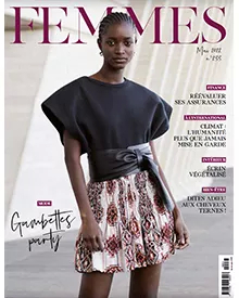 Magazine cover of Femmes featuring a dark-skinned woman in a black top and patterned skirt, with text in French.