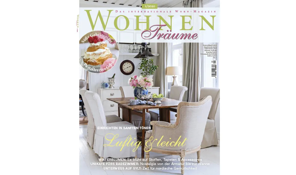 Magazine cover of Wohnen & Träume, featuring a dining room with elegant furniture and flowers.