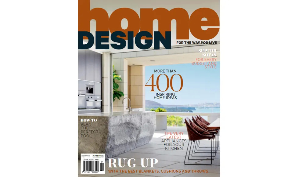 Home Design Magazine cover featuring a modern kitchen with a stone island and an ocean view.