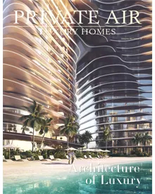 Private Air Luxury Homes magazine cover showing two modern, wavy high-rise buildings next to a beach and pool.