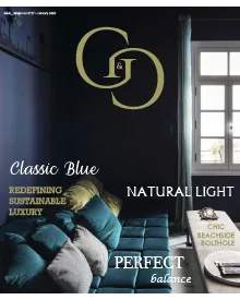 G&G magazine cover with a classic blue room featuring a teal sofa and natural light from a window.