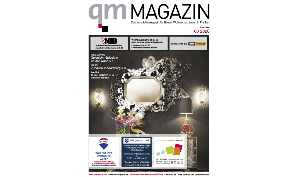 Press clipping of QM Magazin cover with an ornate mirror, a lamp, and flowers in a dark room.