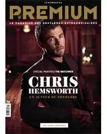 Premium magazine cover featuring Chris Hemsworth, Un Acteur du Tonnerre, in a dark suit against a dim background.