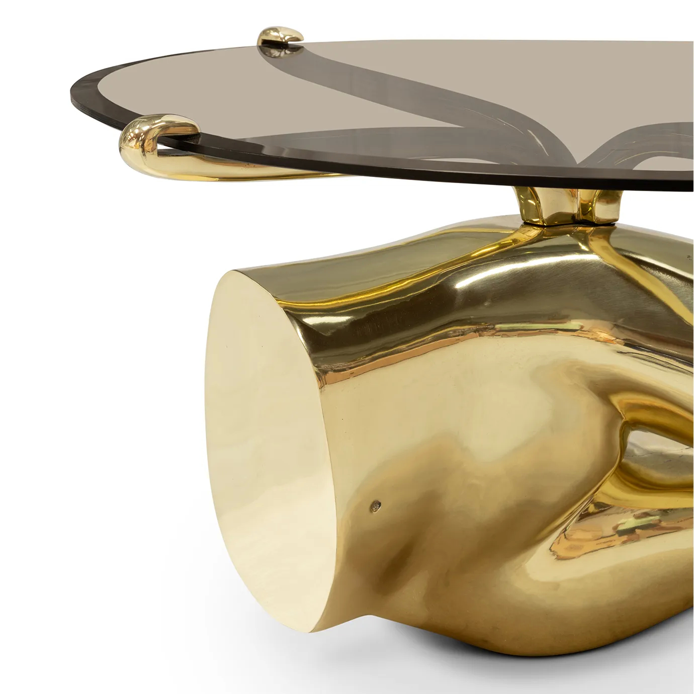 The Tabu Polished Brass Coffee Table features an oval glass top and a highly detailed, sculptural brass base of a reclining figure.