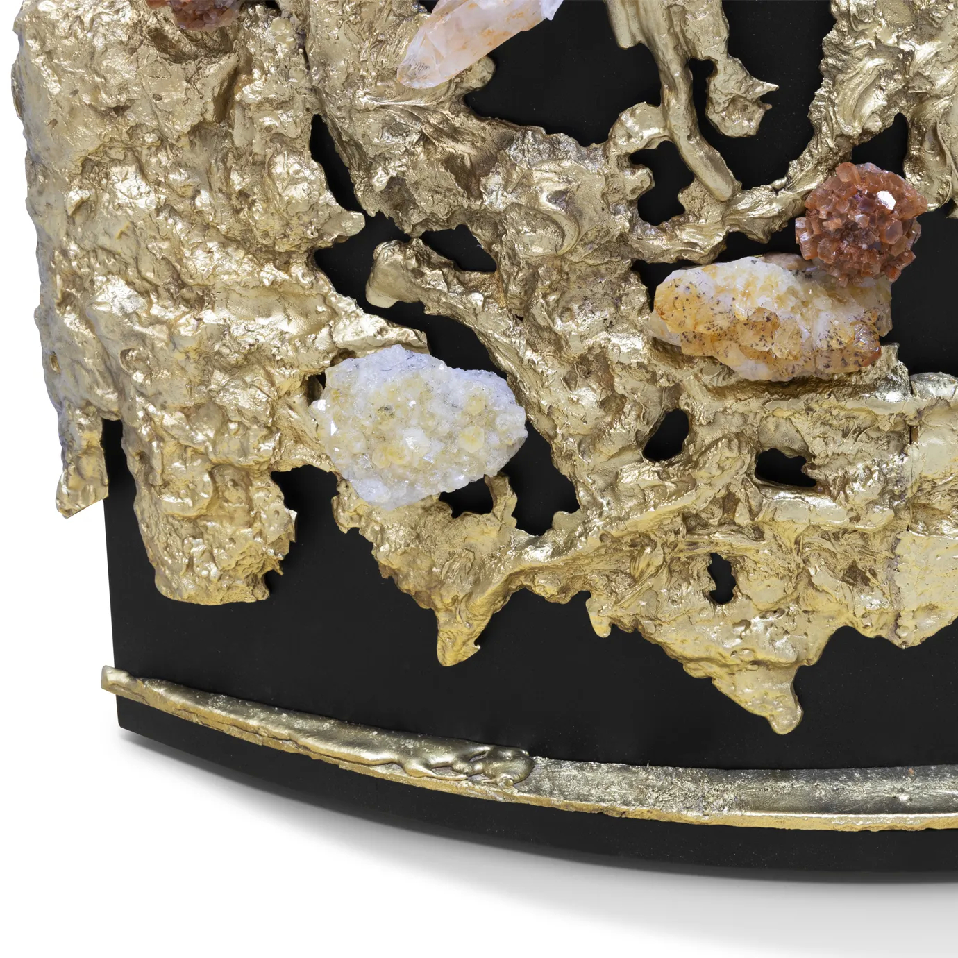 Close-up of natural crystal inlays—aragonite, Brazilian citrine, and clear quartz—set within the cast brass façade.