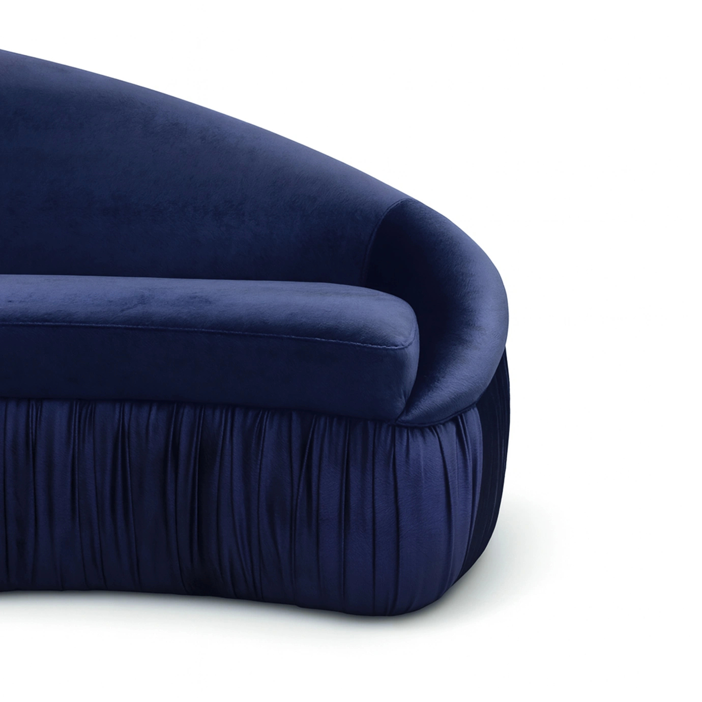 Vamp Full Upholstery Sofa in curved navy blue velvet with fringe detail, featuring a smooth rounded back and seat in a luxurious, modern interior setting.