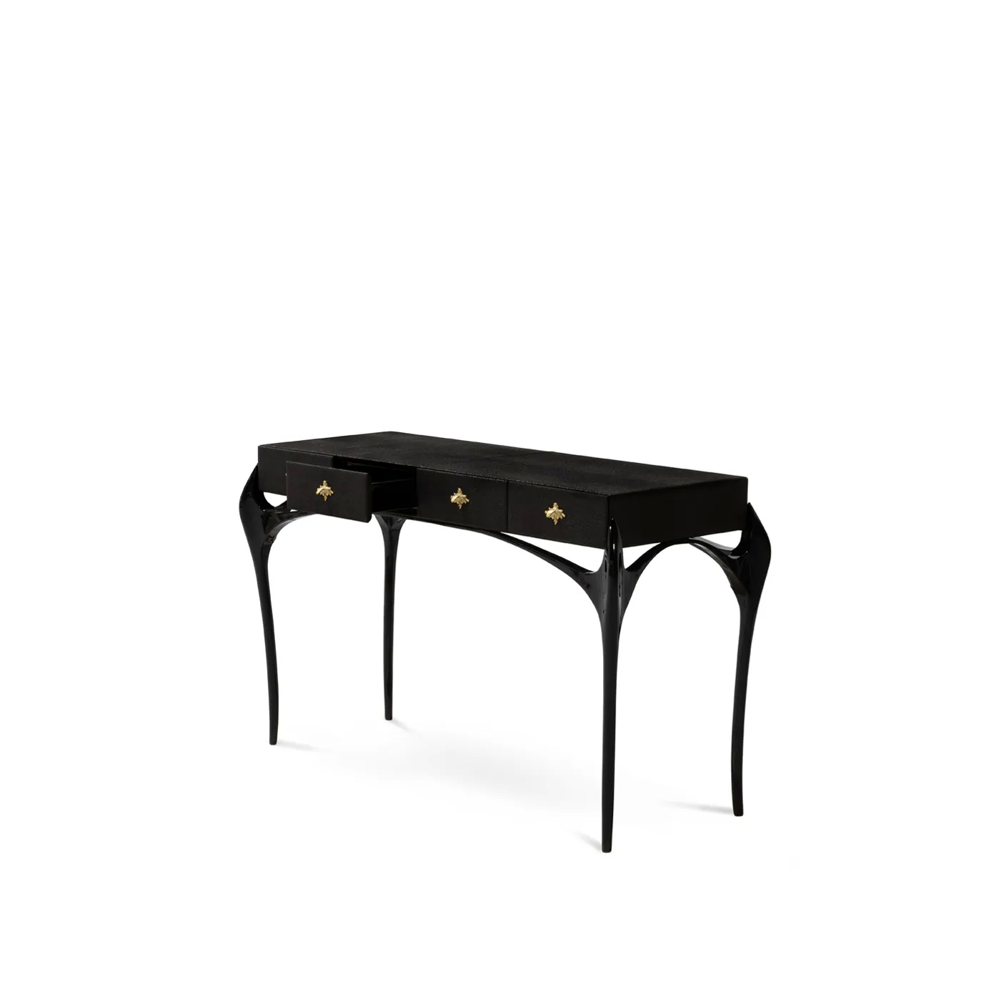 Elegant Temptation Console with a long black tabletop and four drawers, one of which is partially open, adorned with decorative golden star-shaped handles, and a frame with curved black legs and a sculptural golden detail at the base.