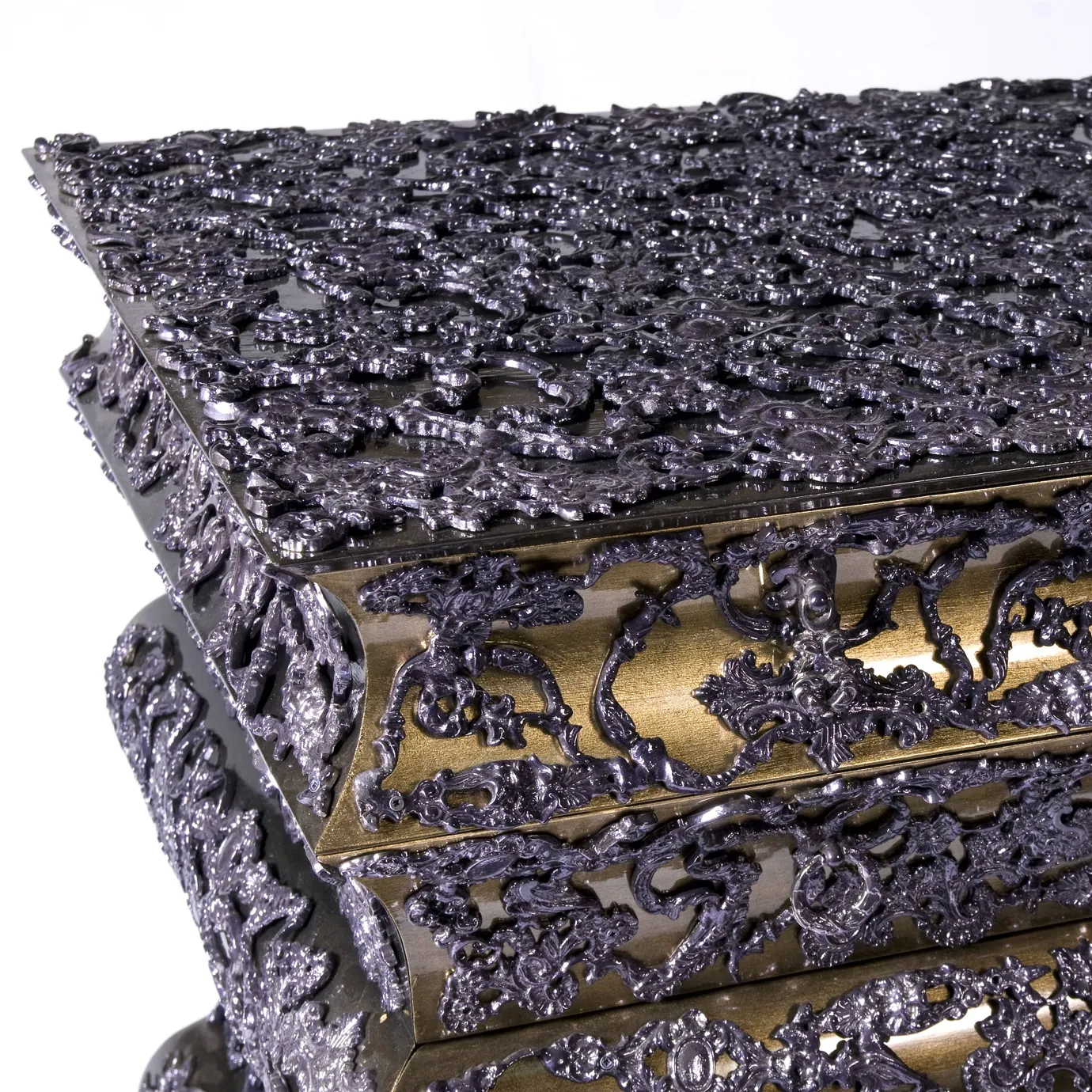 Luxurious gold chest with four drawers, hammered metal texture, and crochet-inspired pattern.