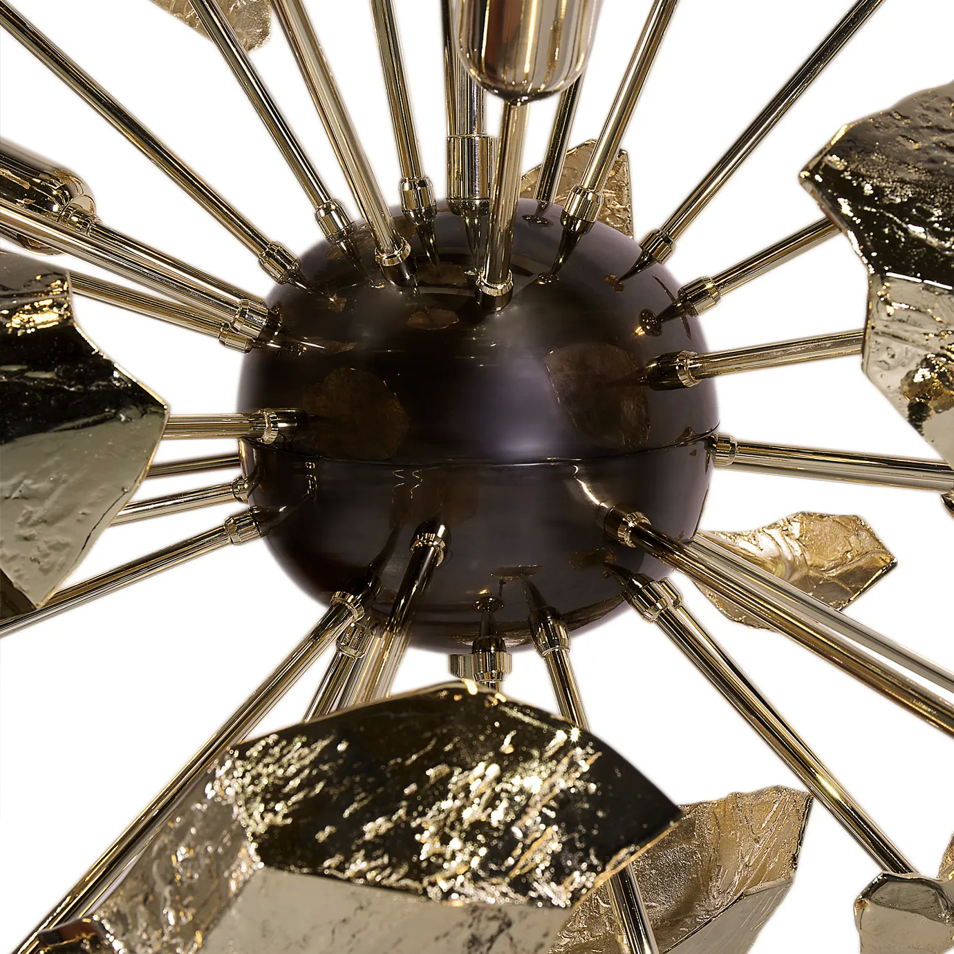 Close-up of the Supernova chandelier’s center, showcasing sleek metalwork and precise detailing in its modern, sculptural lighting design