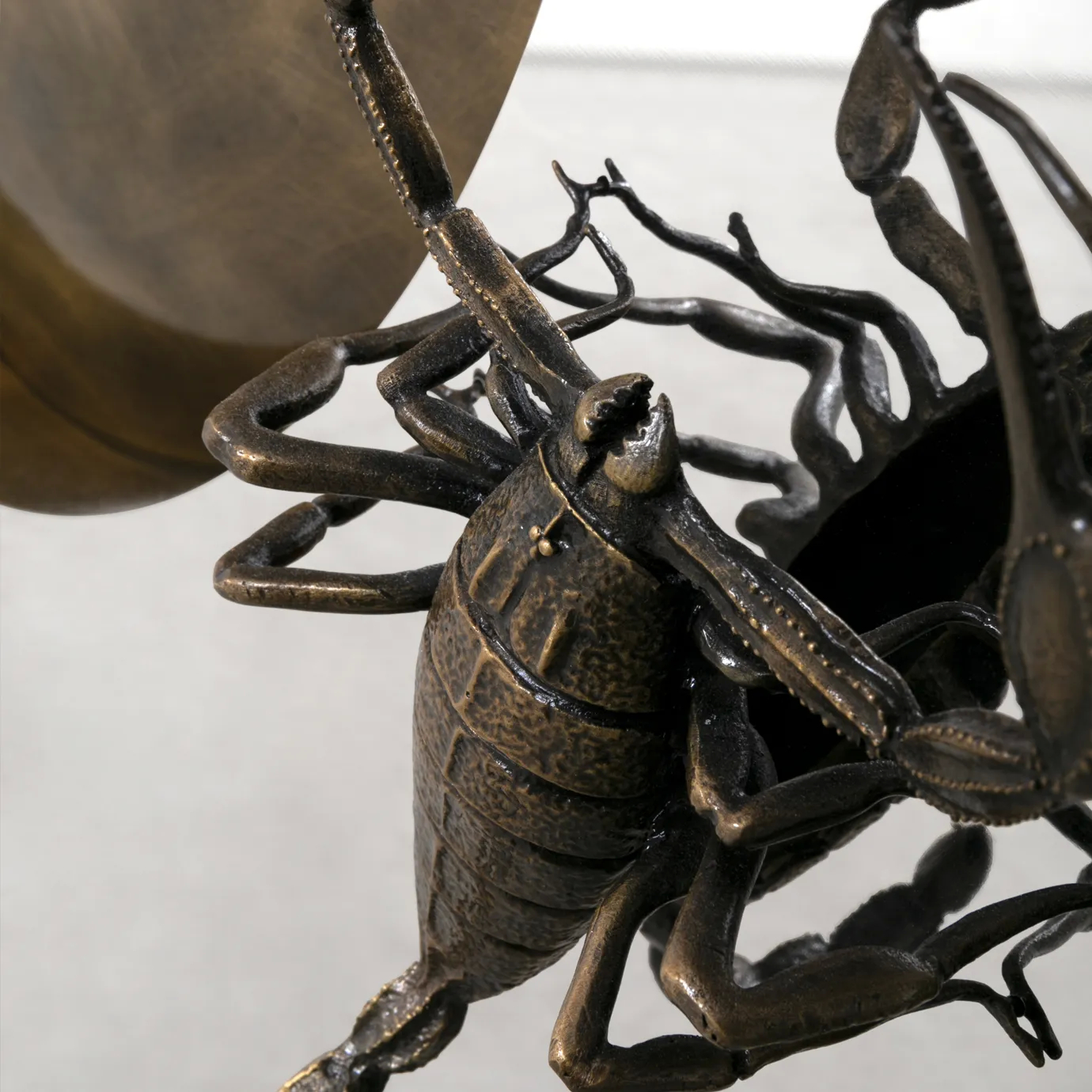 Close-up of Metamorphosis Console, highlighting the scorpion’s stinger with intricate sculptural detailing.