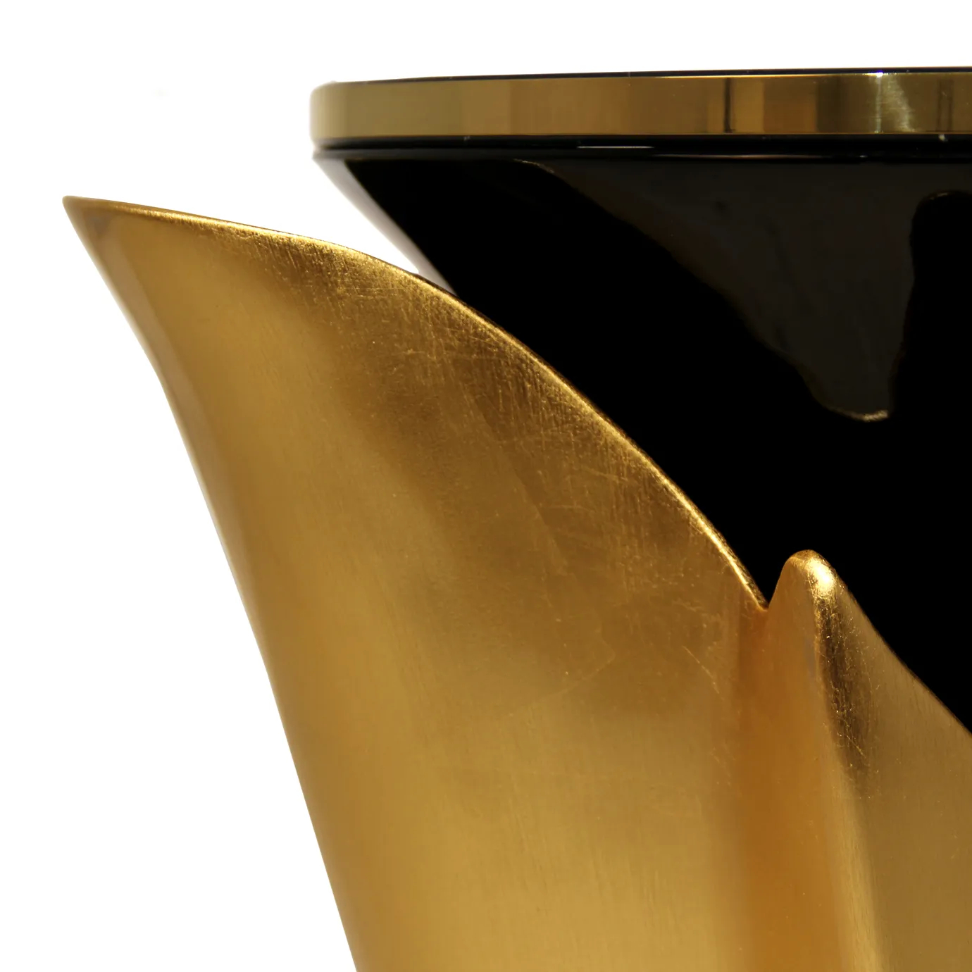 A close-up of the Yasmine Side Table shows the intricate details of its polished brass base and black lacquered body.