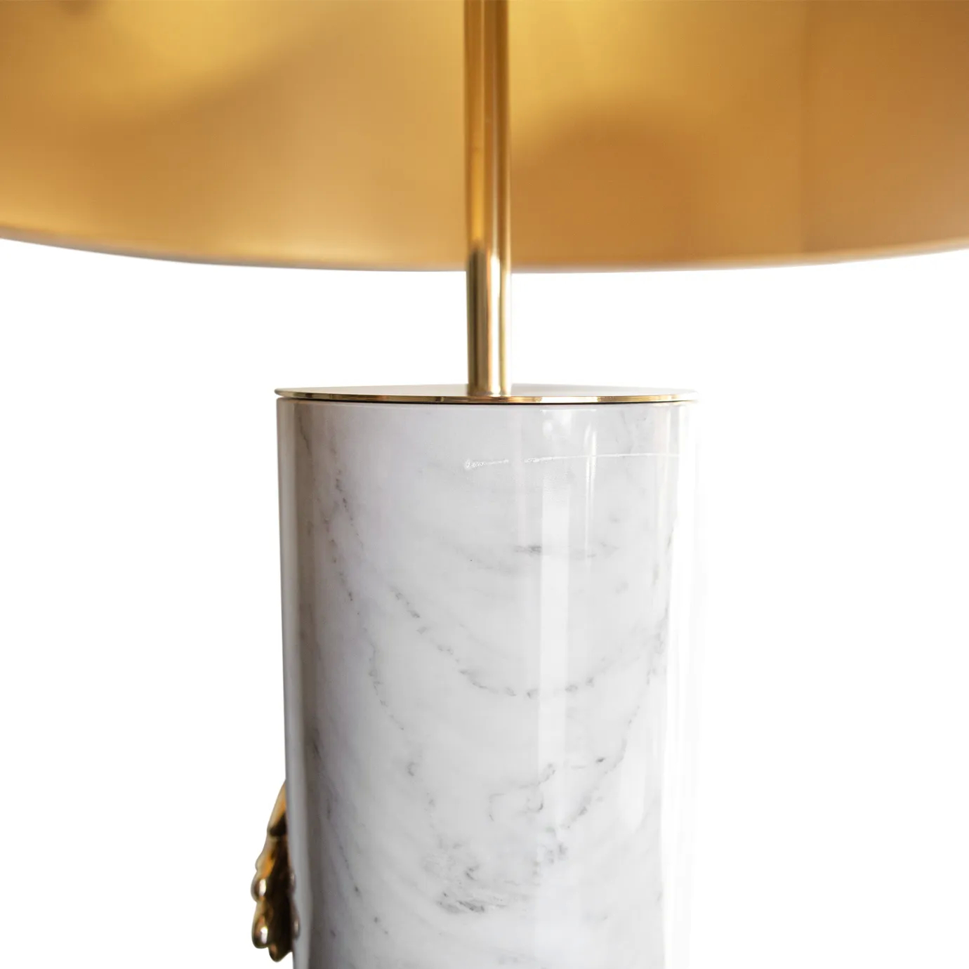 A close-up of the Vengeance Table Lamp by Koket, focusing on its white marble base and the elegant gold elements.