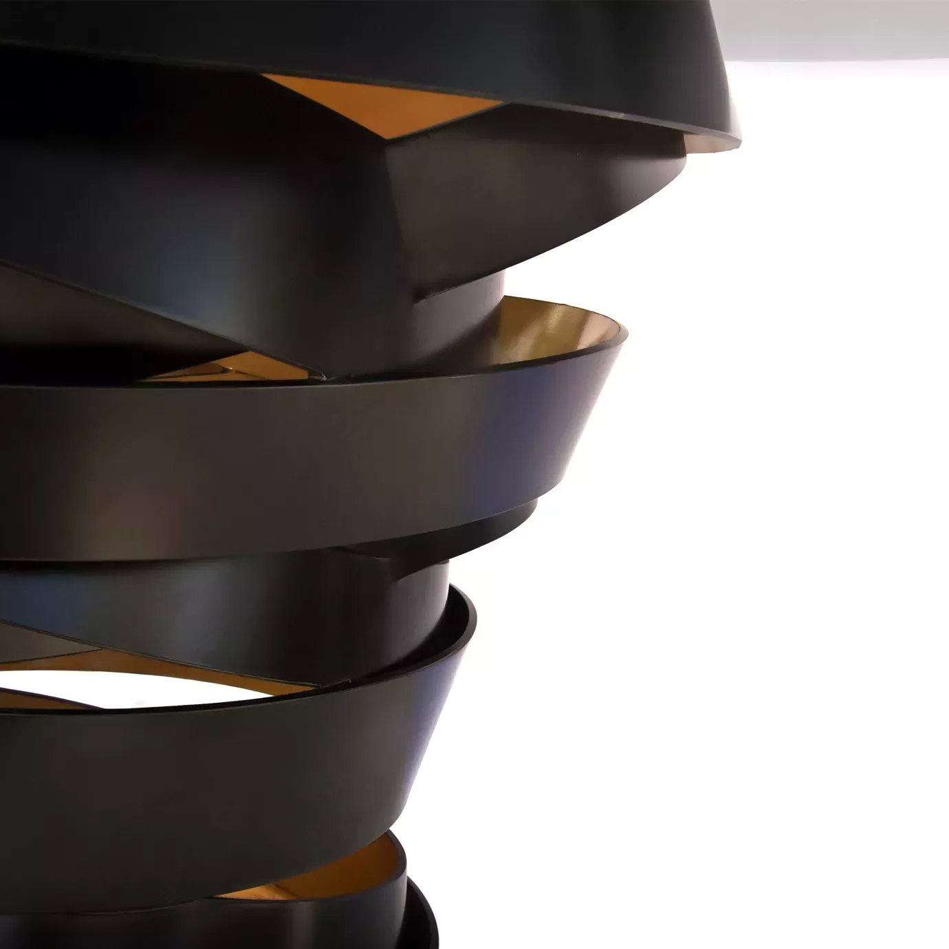 Close look on the Intuition Dining Table’s swirling structure, black on the outside and golden on the inside.