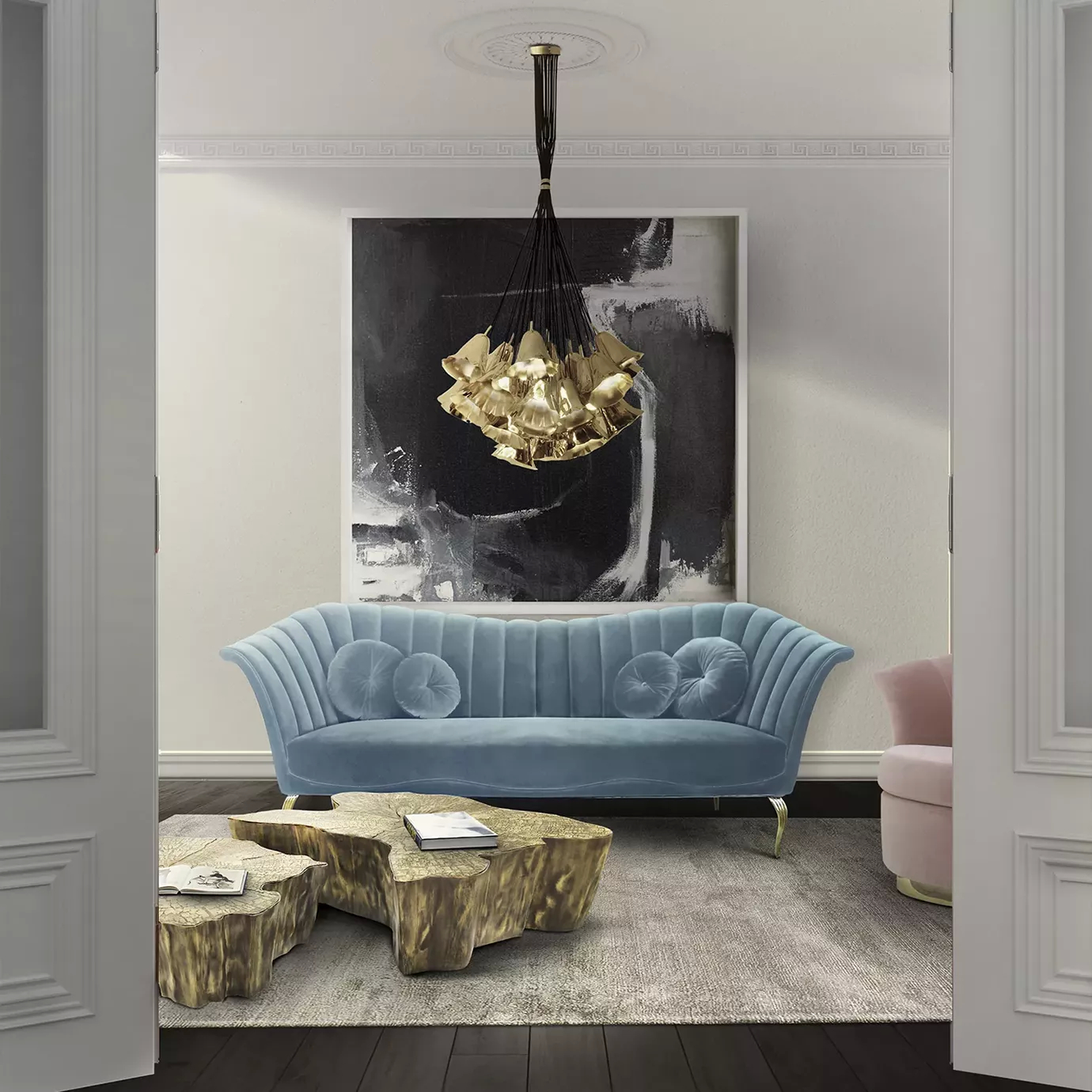 Elegant living room with a Caprichosa Sofa in light blue velvet with a golden base and matching round cushions