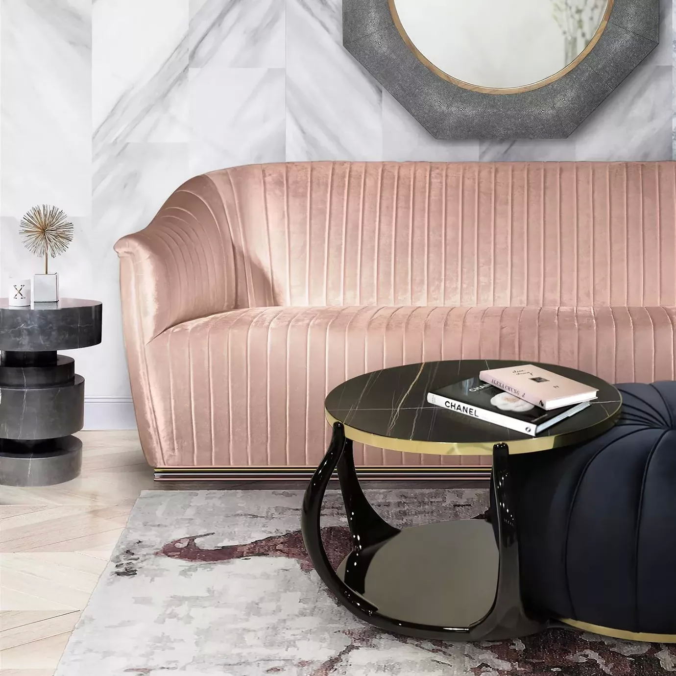 Elegant living room with a Mia Sofa in pale pink fabric with pleated details and a base with brass, a coffee table with a black marble top and black and gold base, and a stylish dark blue ottoman.