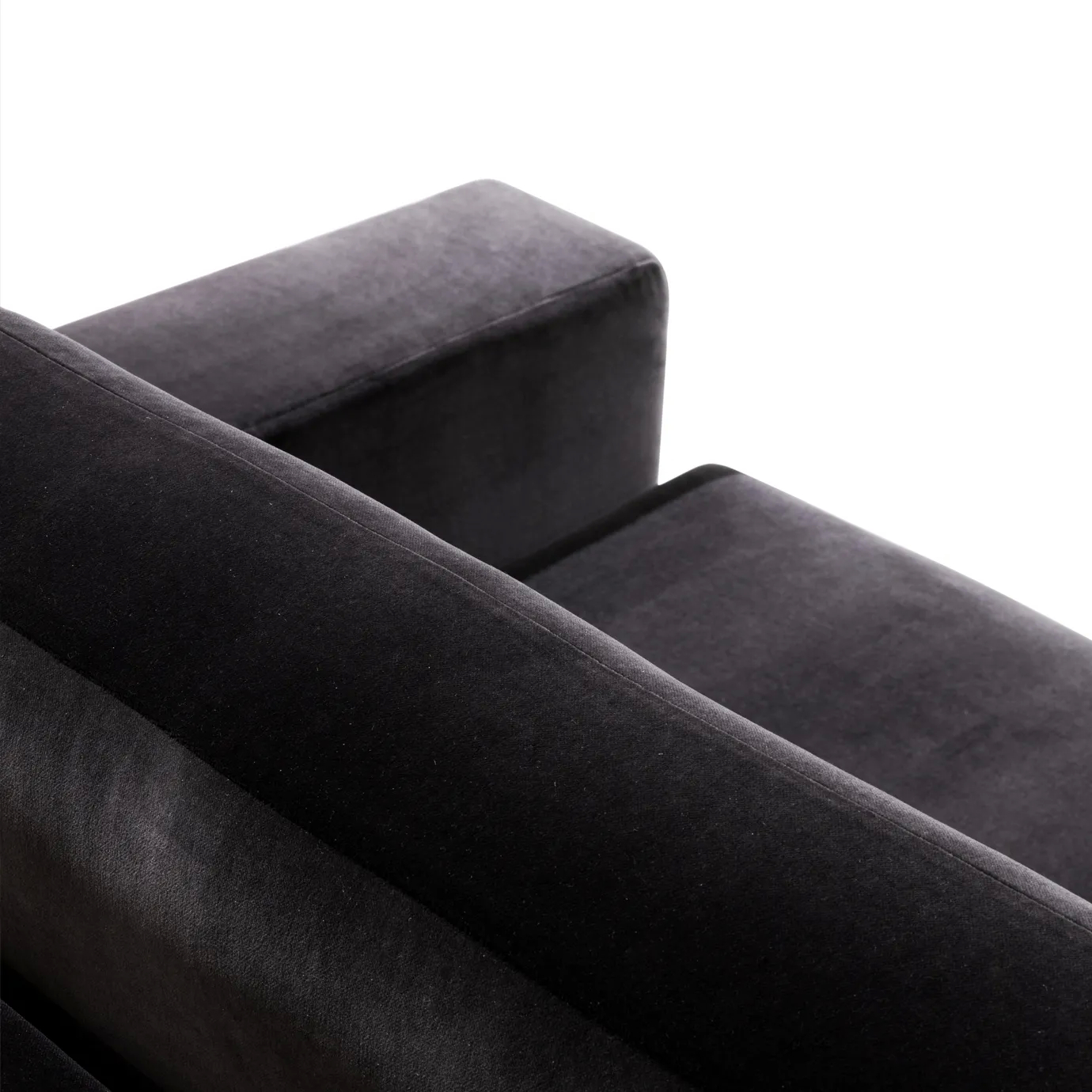 A close-up of the Sofia Sofa shows the luxurious texture of its deep black velvet upholstery on the armrest and cushions.