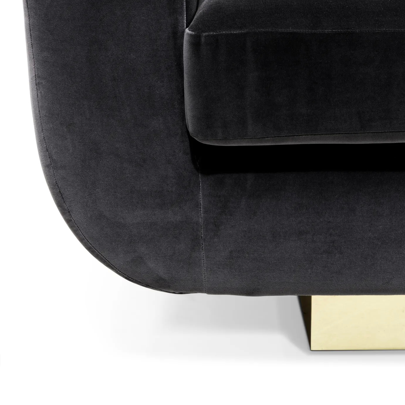 A close-up of the Sofia Sofa shows the rich black velvet upholstery and the sleek, shiny gold detail of its base.