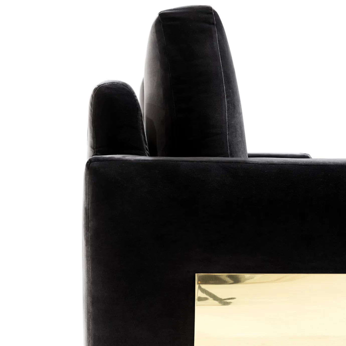 A close-up of the Sofia Sofa showcases the rich black velvet upholstery and the sleek, reflective gold detail on its side.