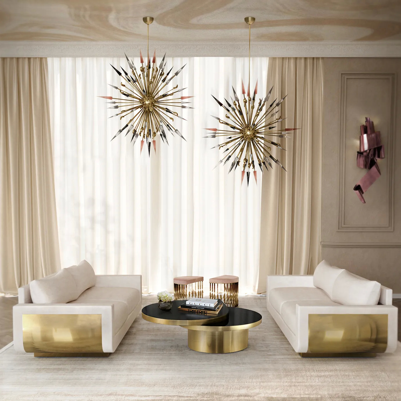 Two luxurious Sofia Sofas in light cream velvet with gold bases face each other in an elegant room with striking pendant lights.
