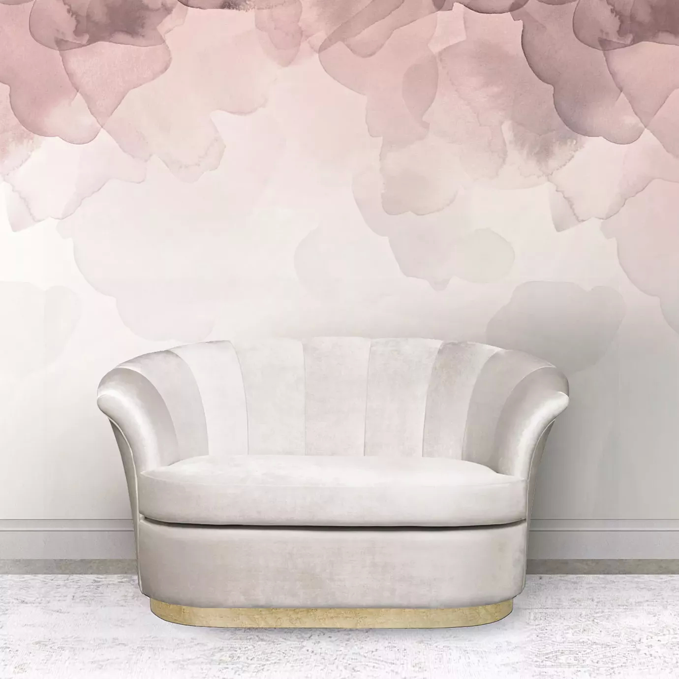 Elegant Besame Sofa with a golden metal base and white fabric upholstery with pleated details against a wall with a soft floral pattern in shades of pink.