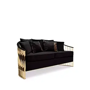 Elegant Mandy Sofa with a golden metal structure featuring a sculptural design and black velvet upholstery with decorative cushions.