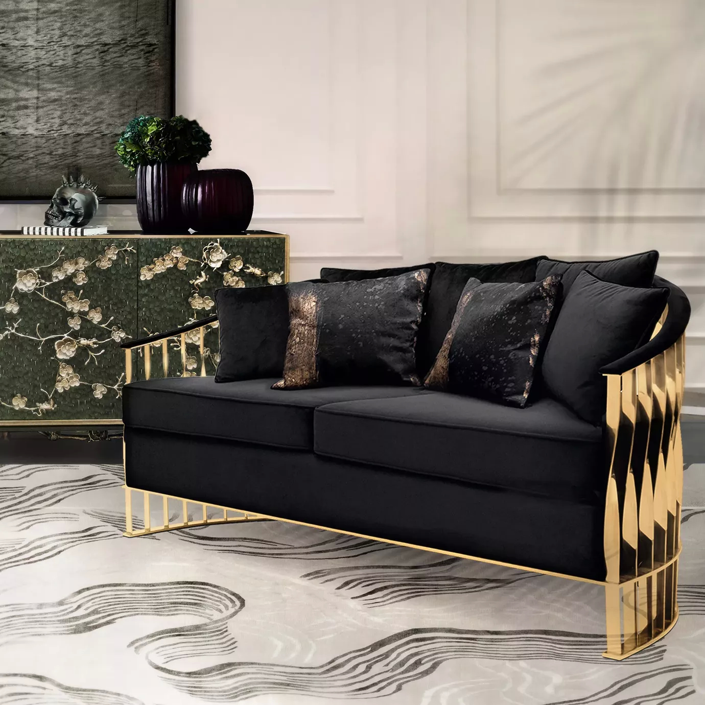 Elegant living room with a Mandy Sofa featuring a sculptural golden metal structure and black velvet upholstery with decorative cushions, a Spellbound Peacock Feather Cabinet, and a modern rug with a wavy pattern.