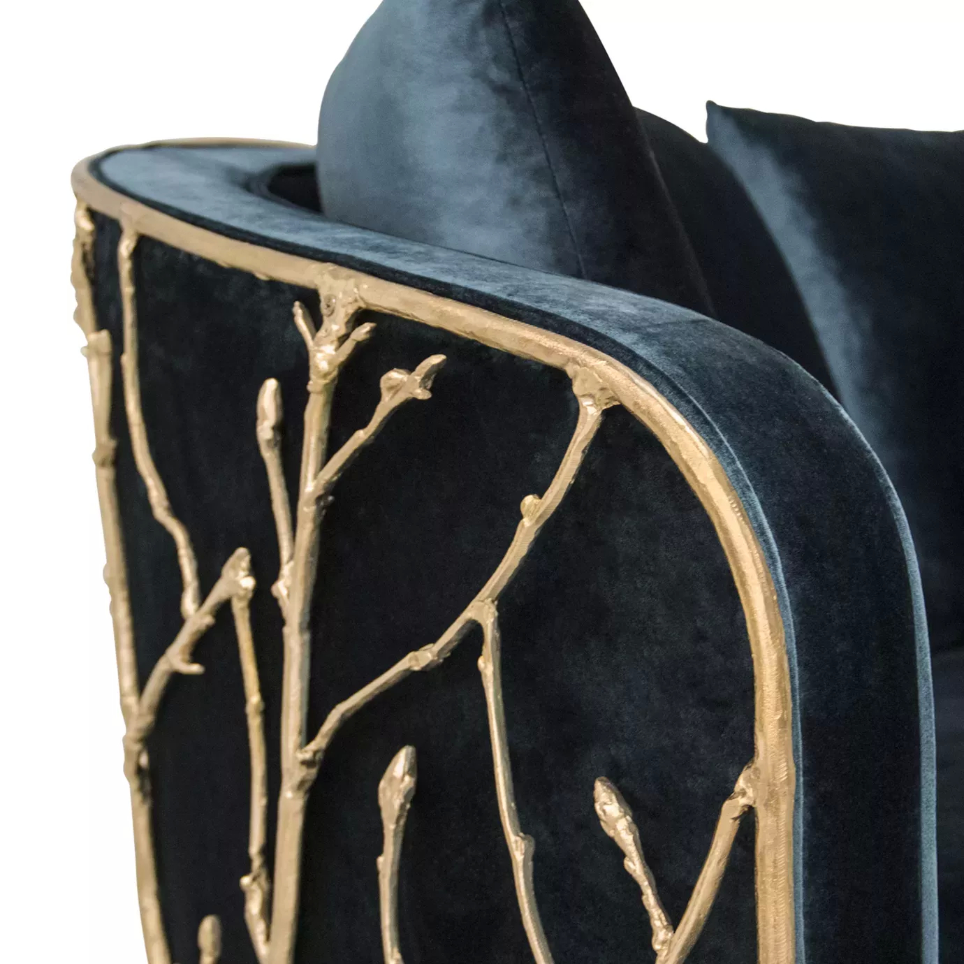 Detailed view of the Enchanted Sofa, showcasing its intricate aged brass structure resembling branches, contrasting with the elegant dark green upholstery.