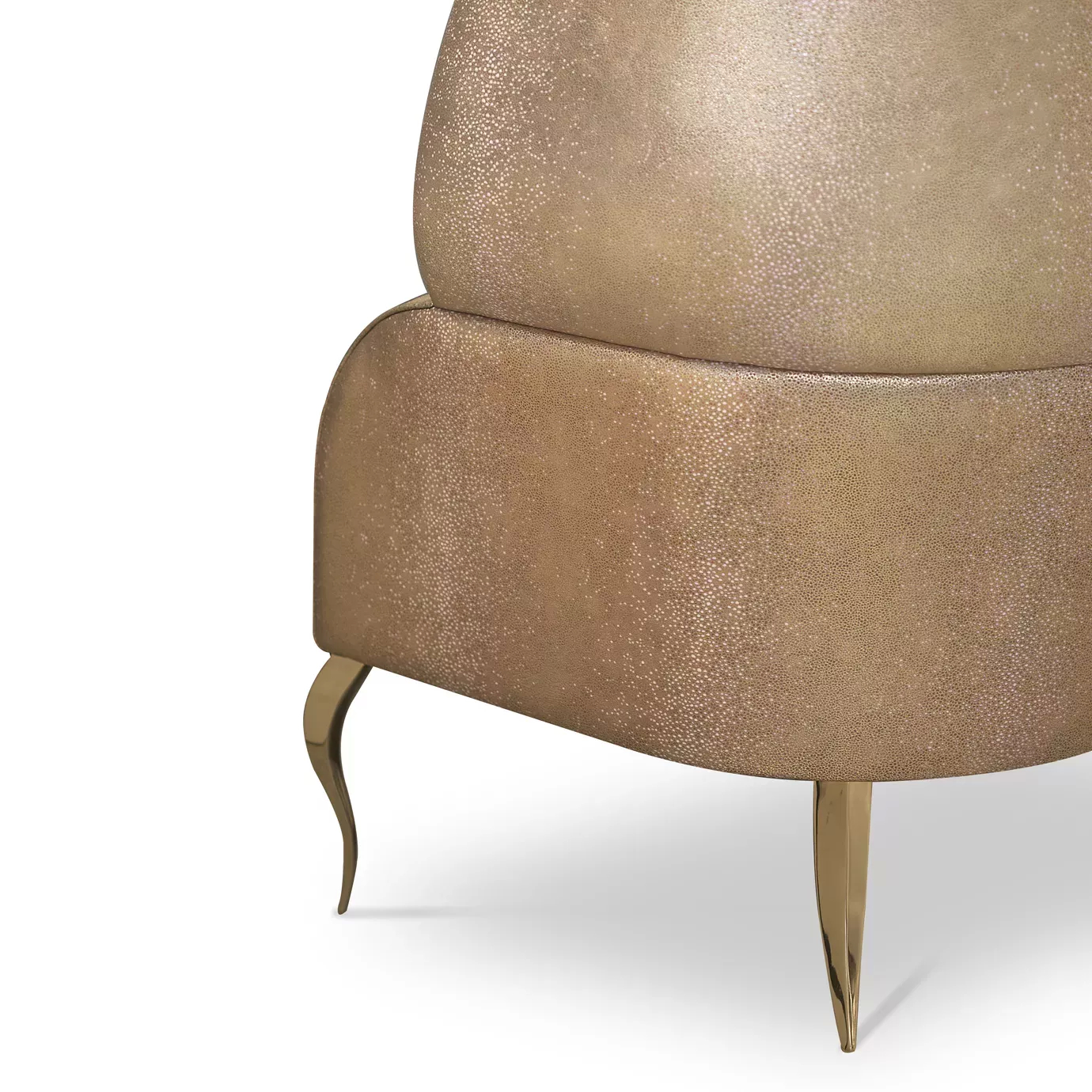 Elegant close-up of the golden textured leather outer structure and the golden metal legs of the Drapesse Sofa.