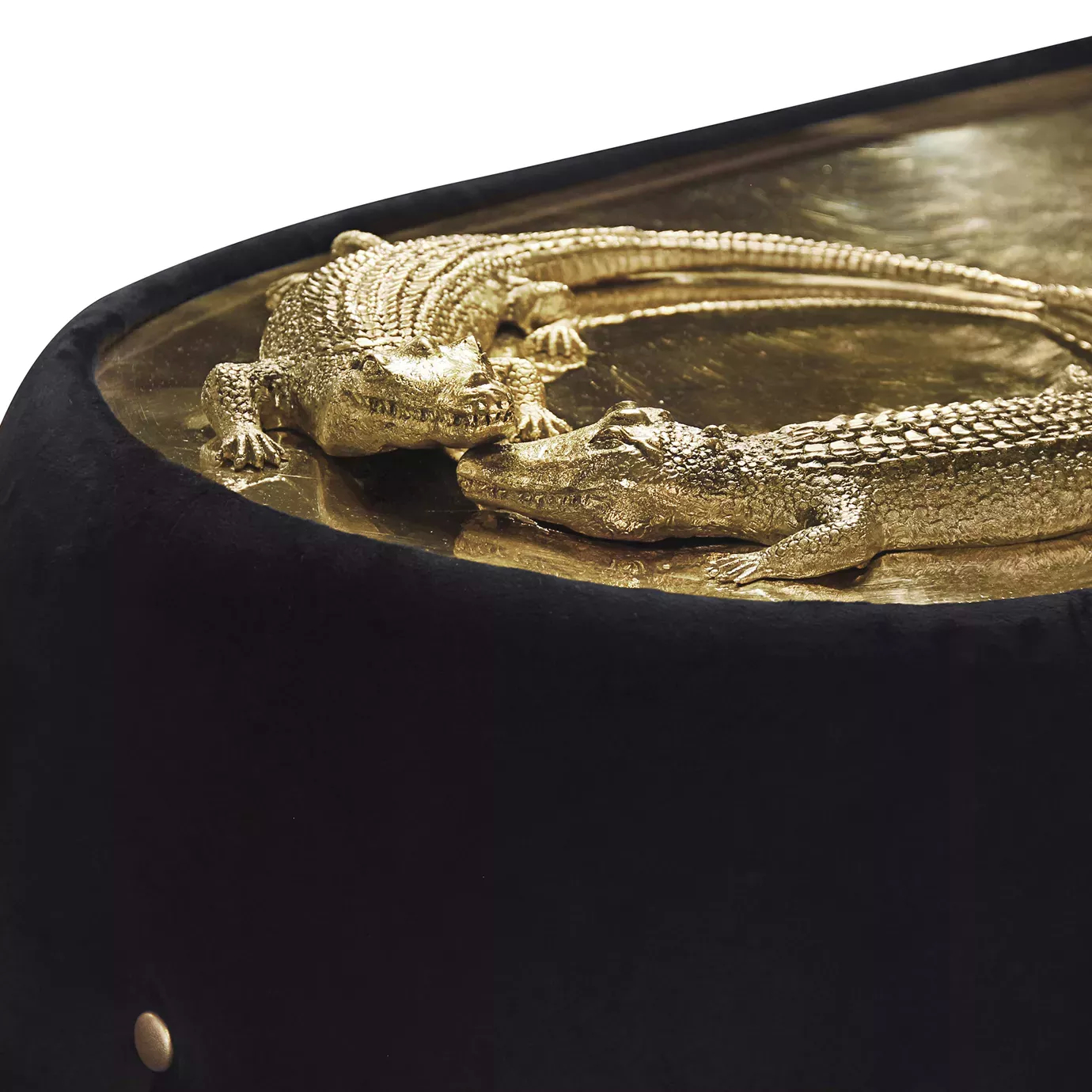 Elegant close-up of the golden metal detail with crocodile sculptures of the Reptilia Sofa with black velvet upholstery.
