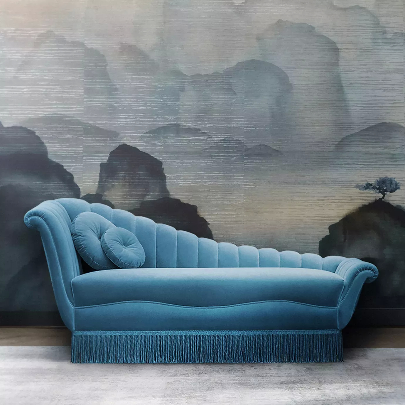 Elegant Millicent Chaise with vibrant blue velvet upholstery and pleated details in a sophisticated setting with artistic wallpaper.