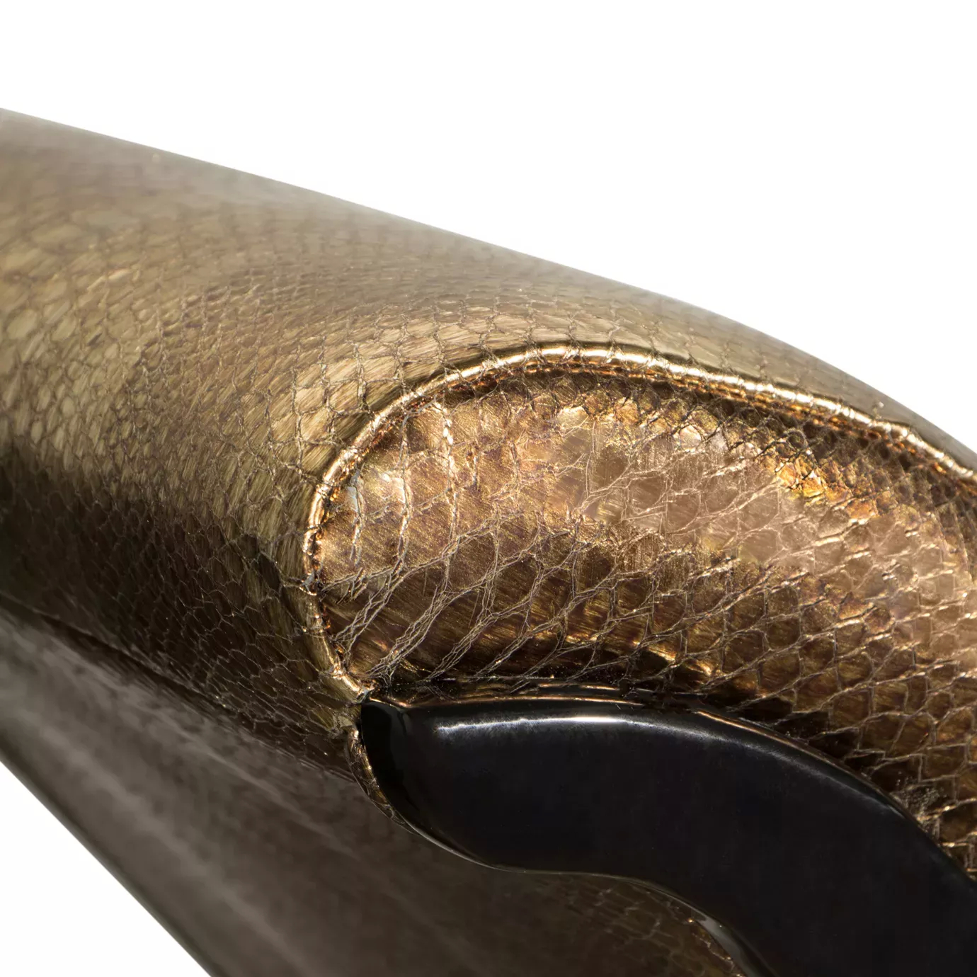 Elegant close-up of the textured leather upholstery with snakeskin pattern in golden tones of the Zeba Chaise.